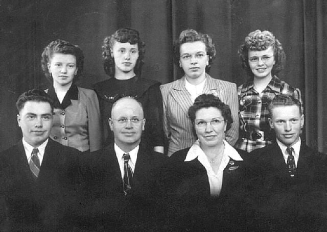 photo: Family portrait of Norman Rost family: back row - Alice, Rosie, Reva and Irene. Front row - Merrill, Norman, Bertha and Mervin. photo: Family portrait of Norman Rost family: back row - Alice, Rosie, Reva and Irene. Front row - Merrill, Norman, Bertha and Mervin.